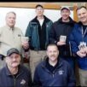 Men give devotional books to first responders following mudslide